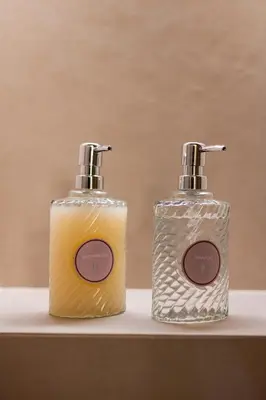 two bottles of soap sitting on top of a counter at The Athenian Aroma - Suite with Jacuzzi in Athens
