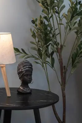 a bust of a woman sitting on a table next to a plant at Modern Seaside 2BR APT in Athens