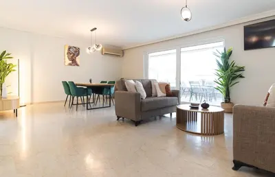 a living room with a couch and a table at Modern Seaside 2BR APT in Athens