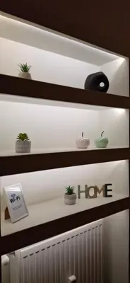a shelf with plants and a home sign on it at Xenia's Elegant Acropolis Suite in Athens