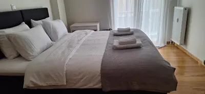 a large bed with white sheets and pillows on it at Xenia's Elegant Acropolis Suite in Athens