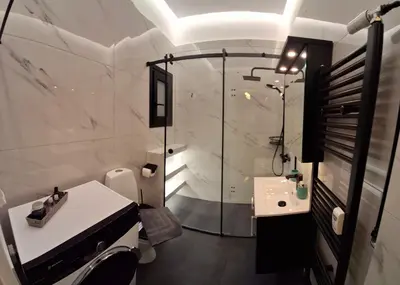 a bathroom with a shower and a sink at Xenia's Elegant Acropolis Suite in Athens