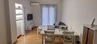 a kitchen with a table and chairs in a room at Xenia's Elegant Acropolis Suite in Athens