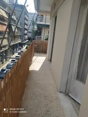 a long hallway of a building with a fence at LUCY maison in Athens