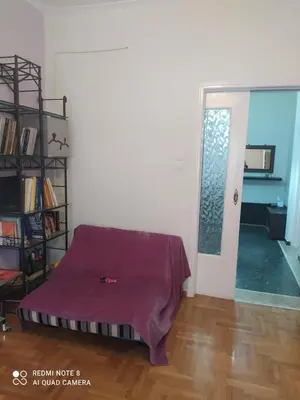 a room with a bed with a purple sheet on it at LUCY maison in Athens
