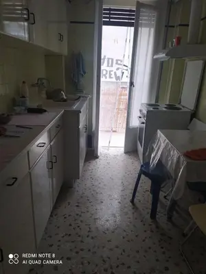 a kitchen with a table and a door to a yard at LUCY maison in Athens