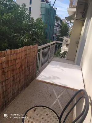 a balcony with a bench and a fence at LUCY maison in Athens