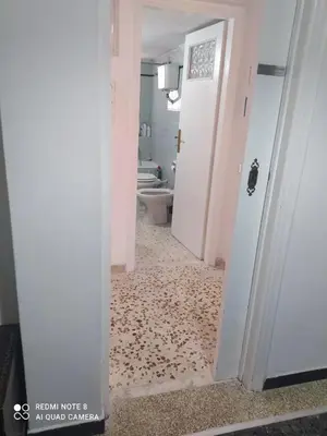 a hallway with a bathroom with a toilet and a doorway at LUCY maison in Athens