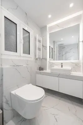 a white bathroom with a toilet and a sink at Spacious & Stylish Athens Apartment - Walk to Metro in Athens