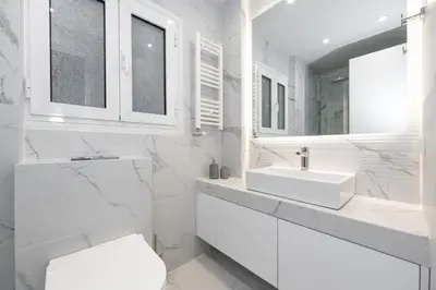 a white bathroom with a sink and a toilet at Spacious & Stylish Athens Apartment - Walk to Metro in Athens