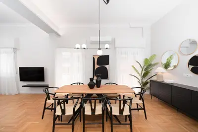 a dining room with a table and chairs at Spacious & Stylish Athens Apartment - Walk to Metro in Athens