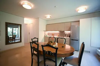 a kitchen with a wooden table and a refrigerator at Tsakalof Penthouse by Zeus Suites in Athens