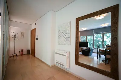 a living room with a mirror on the wall at Tsakalof Penthouse by Zeus Suites in Athens