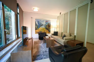 a living room with a couch and a chair at Tsakalof Penthouse by Zeus Suites in Athens