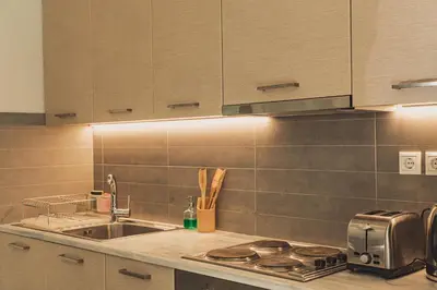 a kitchen with a sink and a stove top oven at Tsakalof Penthouse by Zeus Suites in Athens