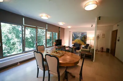 a living room with a dining room table and chairs at Tsakalof Penthouse by Zeus Suites in Athens