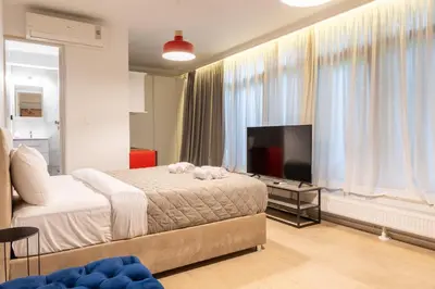 a bedroom with a bed and a flat screen tv at Tsakalof 10A in Athens