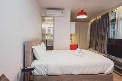 a bedroom with a large bed with white sheets at Tsakalof 10A in Athens