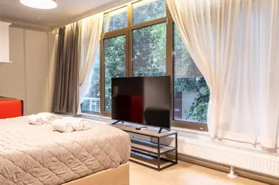 a bedroom with a bed and a flat screen tv at Tsakalof 10A in Athens