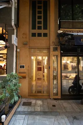 a building with a revolving door on a street at Tsakalof 10A in Athens