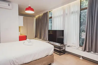 a bedroom with a bed and a flat screen tv at Tsakalof 10A in Athens