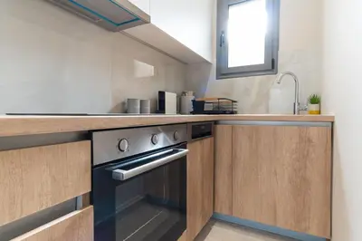 a kitchen with a stove and a sink at Charming minimal apt in the center of Glyfada in Athens
