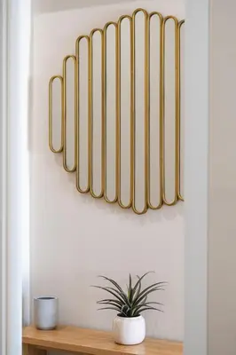 a shelf with a potted plant on a wall at Charming minimal apt in the center of Glyfada in Athens