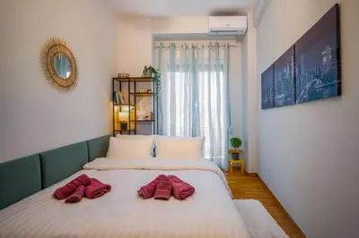 two beds sitting next to each other in a room at Stylish Koukaki Retreat by the Acropolis in Athens