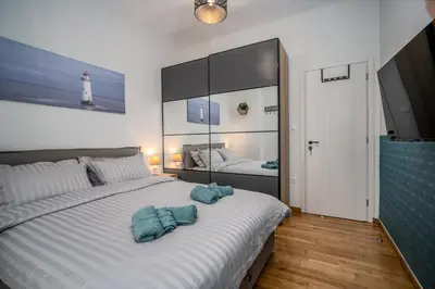 a bedroom with a large white bed with blue towels on it at Stylish Koukaki Retreat by the Acropolis in Athens