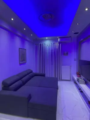 a living room with a couch and a blue ceiling at Apartament Fbi in Athens