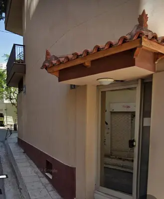 a building with a window on the side of it at Thiseio Home in Athens
