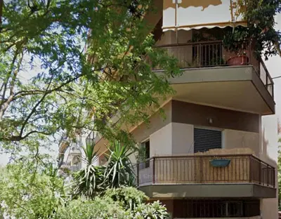 a building with a balcony with plants on it at Thiseio Home in Athens