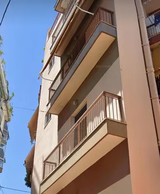 a building with balconies on the side of it at Thiseio Home in Athens