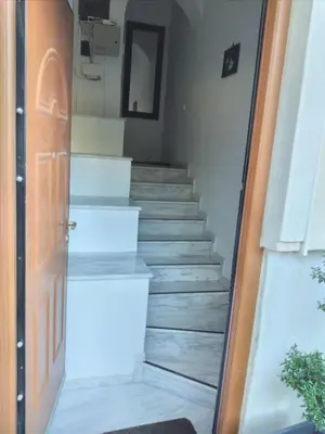 a stairway leading up to a staircase with a door at Penthouse Peaceful Oasis in Lagonissi