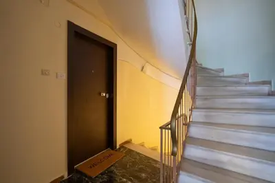 a room with a staircase with a door and a box at Unique Urban Gem in Neapoli Exarcheia in Athens