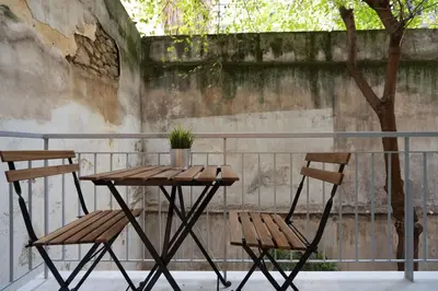 a table and two chairs on a patio at Unique Urban Gem in Neapoli Exarcheia in Athens