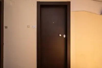a door in a room with a black door at Unique Urban Gem in Neapoli Exarcheia in Athens