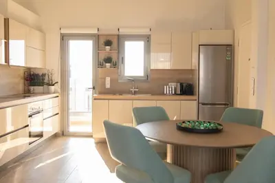 a kitchen with a table and chairs in a kitchen at The Mint House - Alimos in Athens