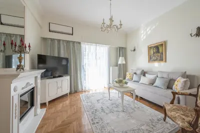 a living room with a couch and a tv at Brand New Luxury Apt Below Acropolis in Athens