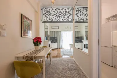 a kitchen and dining room with a table and chairs at Brand New Luxury Apt Below Acropolis in Athens
