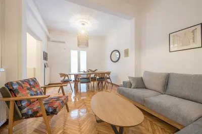 a living room with a couch and a table at Zen Melody, Neapoli in Athens