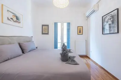 a bedroom with a large bed and a couch at Zen Melody, Neapoli in Athens