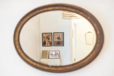 a mirror on a wall with pictures in a room at Zen Melody, Neapoli in Athens