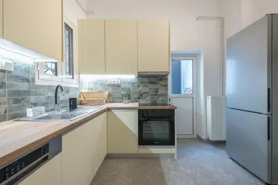 a kitchen with a sink and a refrigerator at Zen Melody, Neapoli in Athens