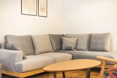a gray couch in a living room with a table at Zen Melody, Neapoli in Athens