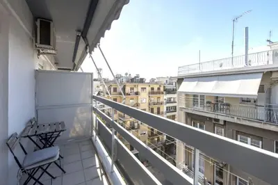 a balcony with a chair and a view of a city at Home away from home in Athens