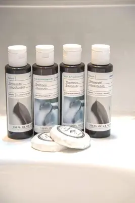 a group of four bottles of paint on a shelf at Home away from home in Athens