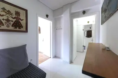 a living room with a couch and a wooden table at Home away from home in Athens