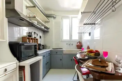 a kitchen with a table with a bowl of fruit on it at Home away from home in Athens