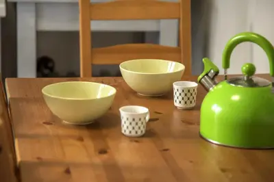 a wooden counter with bowls and cups on a table at Home away from Home in Athens